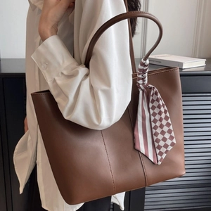 Brown leather tote bag for women with decorative silk scarf and spacious commuter design