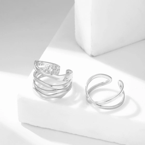 Adjustable silver titanium steel rings with cross layer design on a white geometric stone
