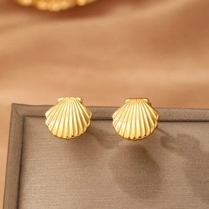 Gold plated stainless steel scallop shell stud earrings in a warm ocean style display