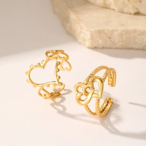 Detail of vintage heart-shaped rings with twisted band texture and hollow metal design