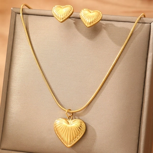 Luxurious gold textured heart jewelry set featuring a necklace and matching stud earrings