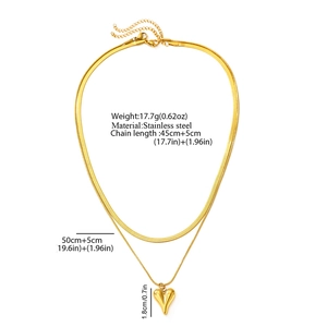 Detail of gold layered stainless steel necklace with snake chain and heart pendant
