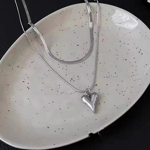 Silver-colored double-layer stainless steel necklace featuring a snake chain and heart pendant