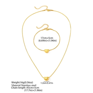 Flat lay of golden stainless steel jewelry set featuring snake chains and bean pendants