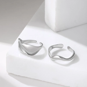 Minimalist silver wavy stainless steel rings set on stone for a modern aesthetic look