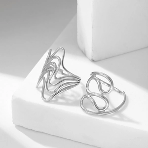 Ensemble de bagues argentées minimalistes au design fluide sur une pierre géométrique