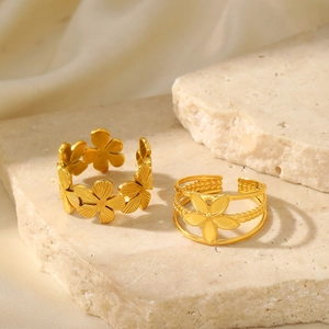 Two-piece gold stainless steel rings set with vintage floral petals on textured stone