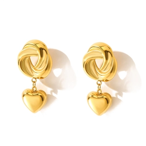 Polished gold spiral twist earrings with heart-shaped pendants on white background