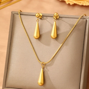 Polished gold stainless steel teardrop jewelry set with necklace and earrings on display