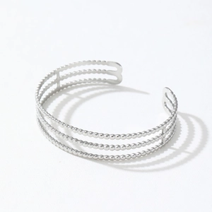 Detailed view of silver triple-layered bead cuff bracelet with high-polish metallic finish