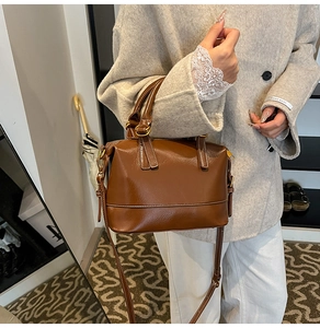 Detail of vintage dark brown oil wax leather Boston bag with antique bronze hardware