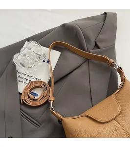 Detailed view of camel hobo bag with pebble leather grain and adjustable shoulder strap