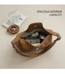 Internal view of brown pebbled leather shoulder bag showing spacious main compartment
