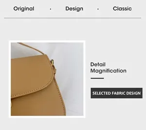 Detail magnification of the camel leather crossbody bag showing stitching and metal hardware