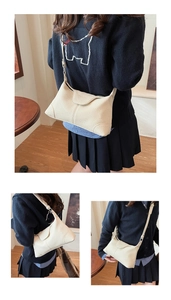 Detail shots of off-white lychee pattern leather shoulder bag with adjustable strap