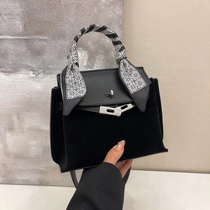 Vintage matte black Kelly bag with silk scarf handle and silver metal buckle closure