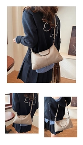 Detailed close-up of beige lychee grain leather shoulder bag with reinforced corners