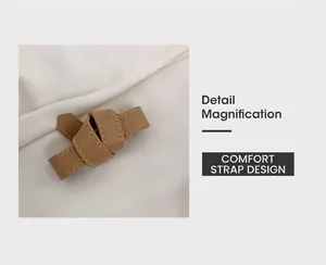 Detail magnification of knotted brown leather shoulder strap with visible contrast stitching