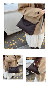 Close-up of brown lychee texture leather shoulder bag with adjustable strap in outdoor light