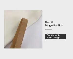 Detail magnification of the light brown leather shoulder strap with neat edge stitching