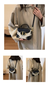 Detail view of contrast stitch mini bag with metallic oval lock and adjustable strap