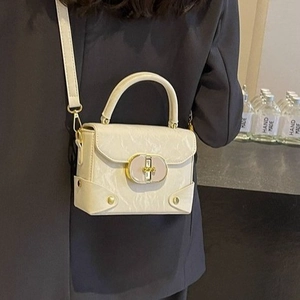 Fashionable cream white crossbody square bag with gold twist lock and top handle