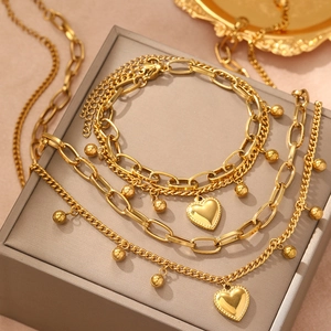 Ensemble collier et bracelet double couche en acier inoxydable doré avec pendentifs cœur
