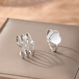 Set of two heart shaped adjustable open rings in polished stainless steel finish