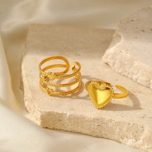 Detail of adjustable 18K gold plated stainless steel heart rings on a stone tray