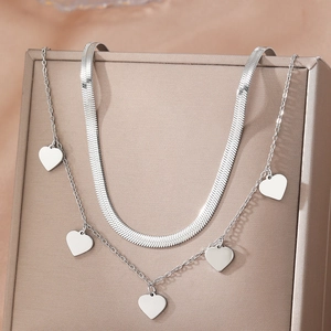 Elegant double-layered silver heart necklace with a sleek snake chain and five heart pendants