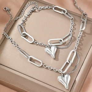 Parure collier et bracelet en acier inoxydable argenté avec pendentif cœur bombé