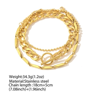 Detail of three-piece gold stainless steel bracelet set with OT toggle clasp and chain textures