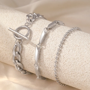 Close-up of three-piece silver stainless steel bracelet set with OT buckle and bead chain