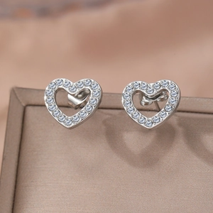 Sweet silver heart-shaped stud earrings with pave crystals on a jewelry display box