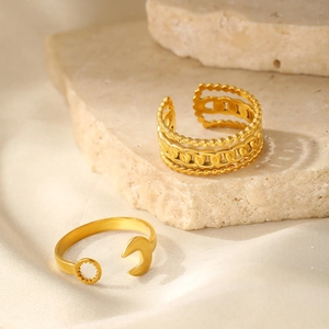 Close-up of gold plated stainless steel rings featuring chain texture and sun-moon design