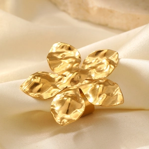 Macro shot of 18K gold plated ring with hammered texture petal design on white silk