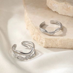 Macro detail of intertwined silver twisted lines and layered metallic ring texture