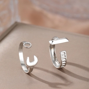 Industrial style silver wrench shaped open ring set in polished stainless steel finish