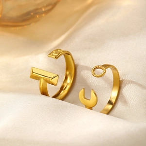 Macro view of gold stainless steel wrench rings on cream silk fabric detail
