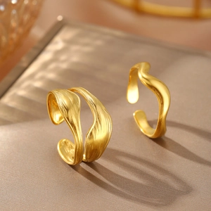 Adjustable gold ripple rings with matte brushed texture in minimalist organic design