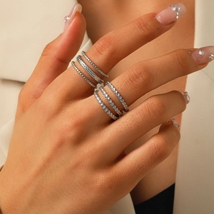 Detail of five-piece silver stackable rings featuring textured leaf and beaded patterns