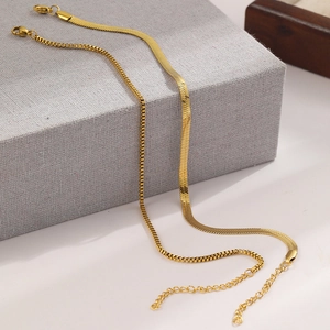 Detail of layered gold stainless steel snake and box chains with adjustable lobster clasp