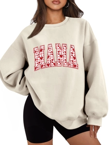 Detail of MAMA lettering with red heart pattern on beige fleece sweatshirt