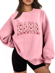 Close-up of pink oversized sweatshirt featuring MAMA text with heart pattern design