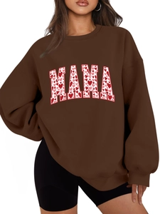 Close-up of MAMA text with red and pink heart patterns on a dark brown hoodie