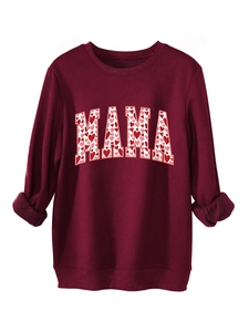 Detail of MAMA lettering with pink heart patterns on dark red fleece sweatshirt