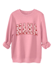 Detail of pink MAMA sweatshirt showing heart pattern lettering and ribbed cuffs