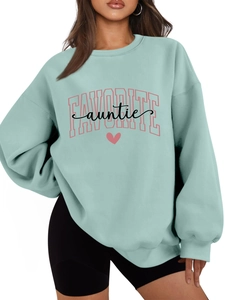 Detail of mint green sweatshirt with pink Favorite Auntie text and heart print