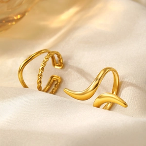Detail of 18K gold-plated adjustable open rings with woven texture on silk fabric