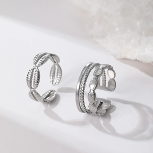 Silver stainless steel geometric rings set featuring textured shell and layered cable designs